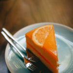 Photo by Madjid Atmania: https://www.pexels.com/photo/a-slice-of-orange-cake-served-on-a-ceramic-plate-with-stainless-steel-forks-12285416/