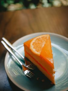 Photo by Madjid Atmania: https://www.pexels.com/photo/a-slice-of-orange-cake-served-on-a-ceramic-plate-with-stainless-steel-forks-12285416/